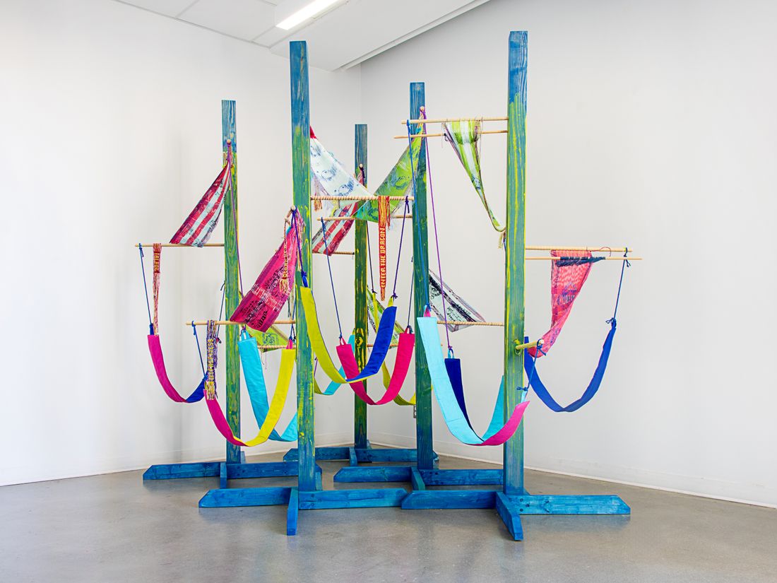An installation shot of an Artist in Residence as Visiting Associate Professor in the Department of Art History, Visual Art & Theory, and John Grace Memorial Artist in Residence at Green College, University of British Columbia, Vancouver, BC. Colorful woven forms using backstrap weaving on posts.