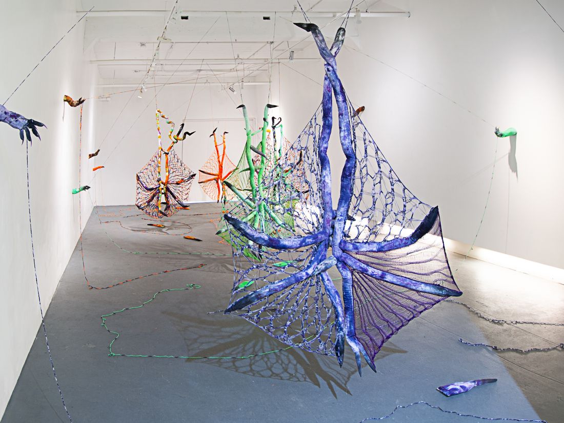 Hand dyed soft sculpture shaped in large bat-like wings where the membranes are knitted with beads.