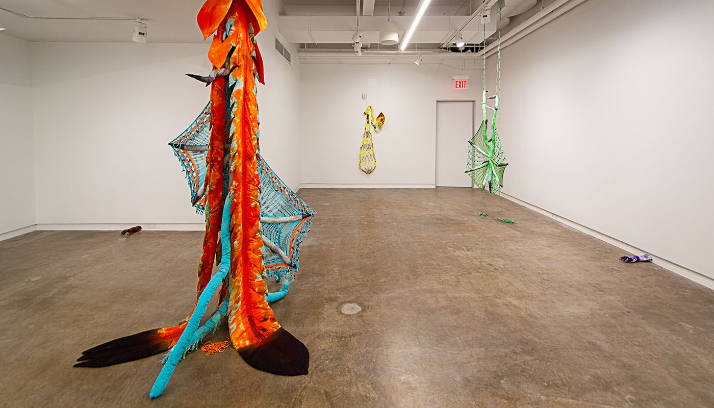 Installation of soft sculptures shaped most in large bat-like wings where the membranes are knitted with beads and hands with nails.