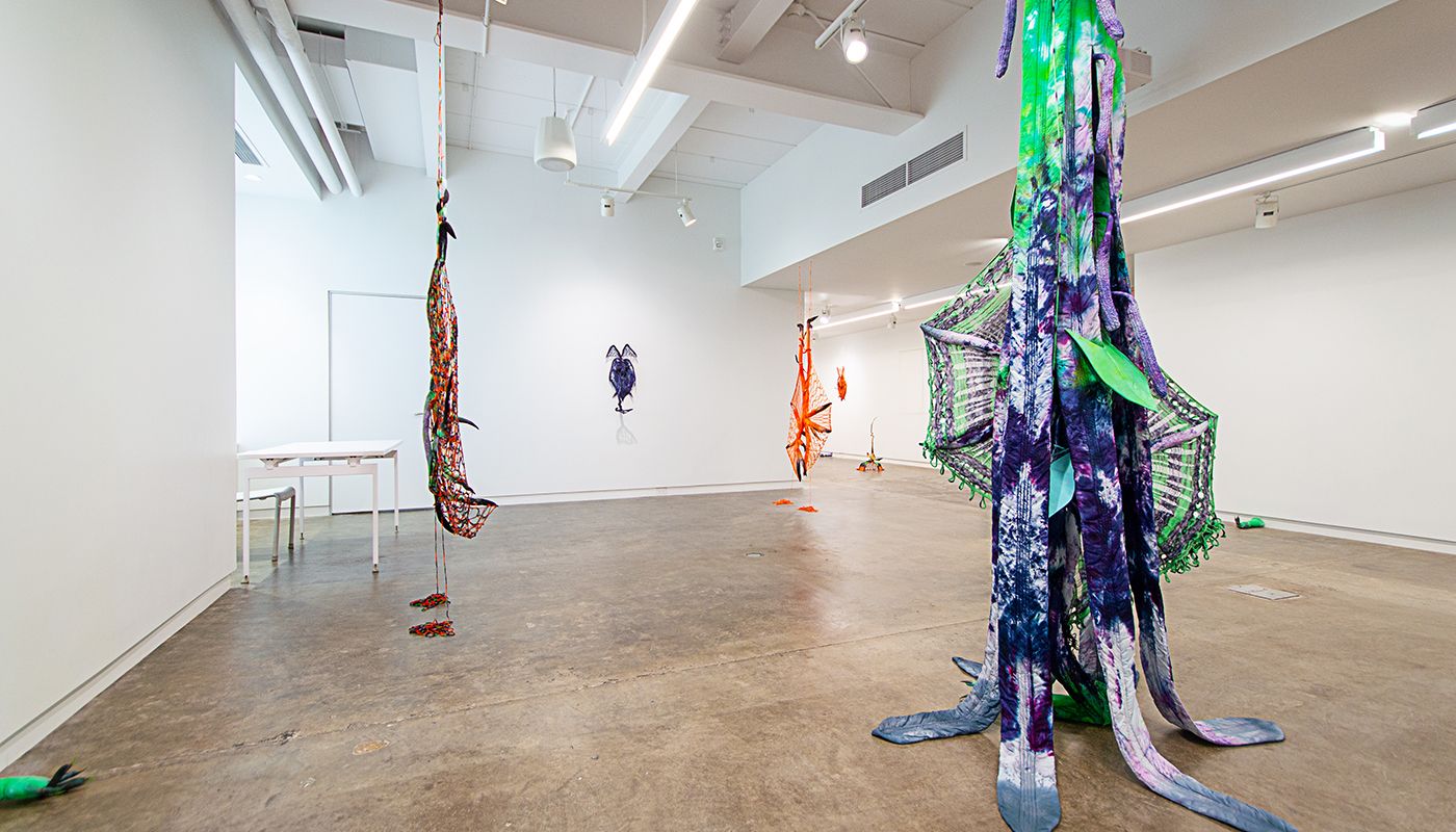 Installation of soft sculptures shaped most in large bat-like wings where the membranes are knitted with beads and hands with nails.