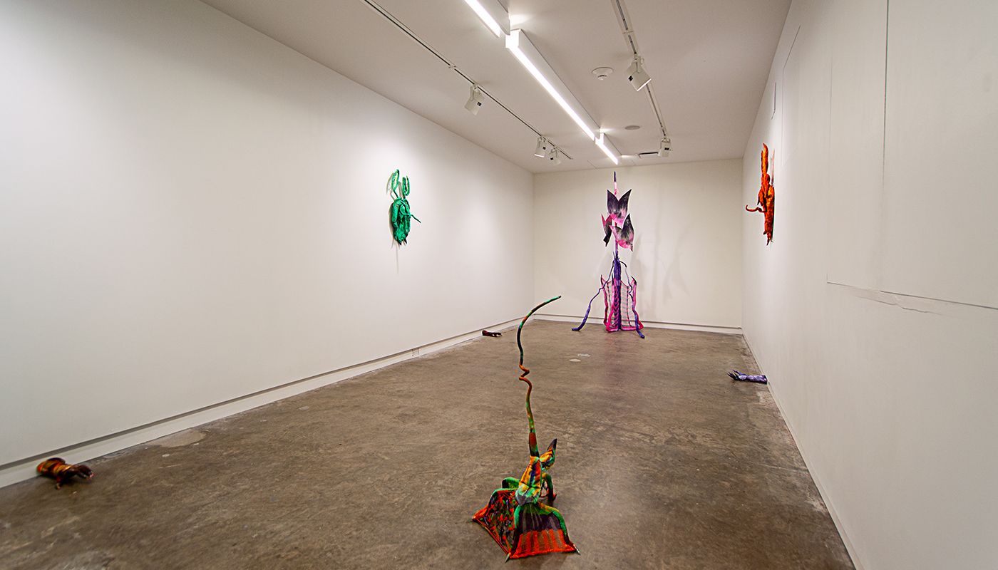 Installation of soft sculptures shaped most in large bat-like wings where the membranes are knitted with beads and hands with nails.