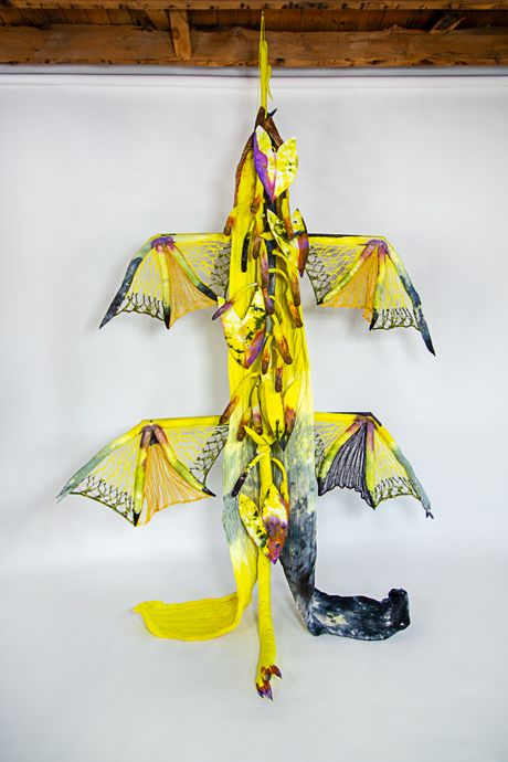 Hand-dyed primarily in yellow, this tall soft sculpture resembles a spadix plant with wide knitted wings.