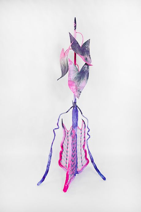 Hand-dyed primarily in pink and purple, this tall soft sculpture resembles a spadix plant with knitted wings.
