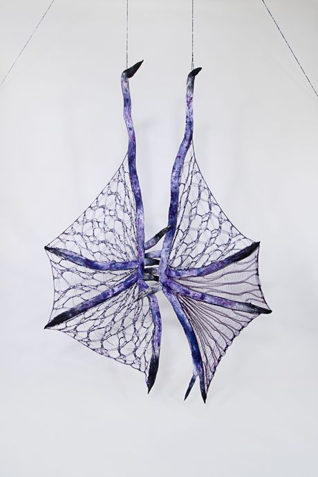 Hand dyed soft sculpture shaped in large bat-like wings where the membranes are knitted with beads.