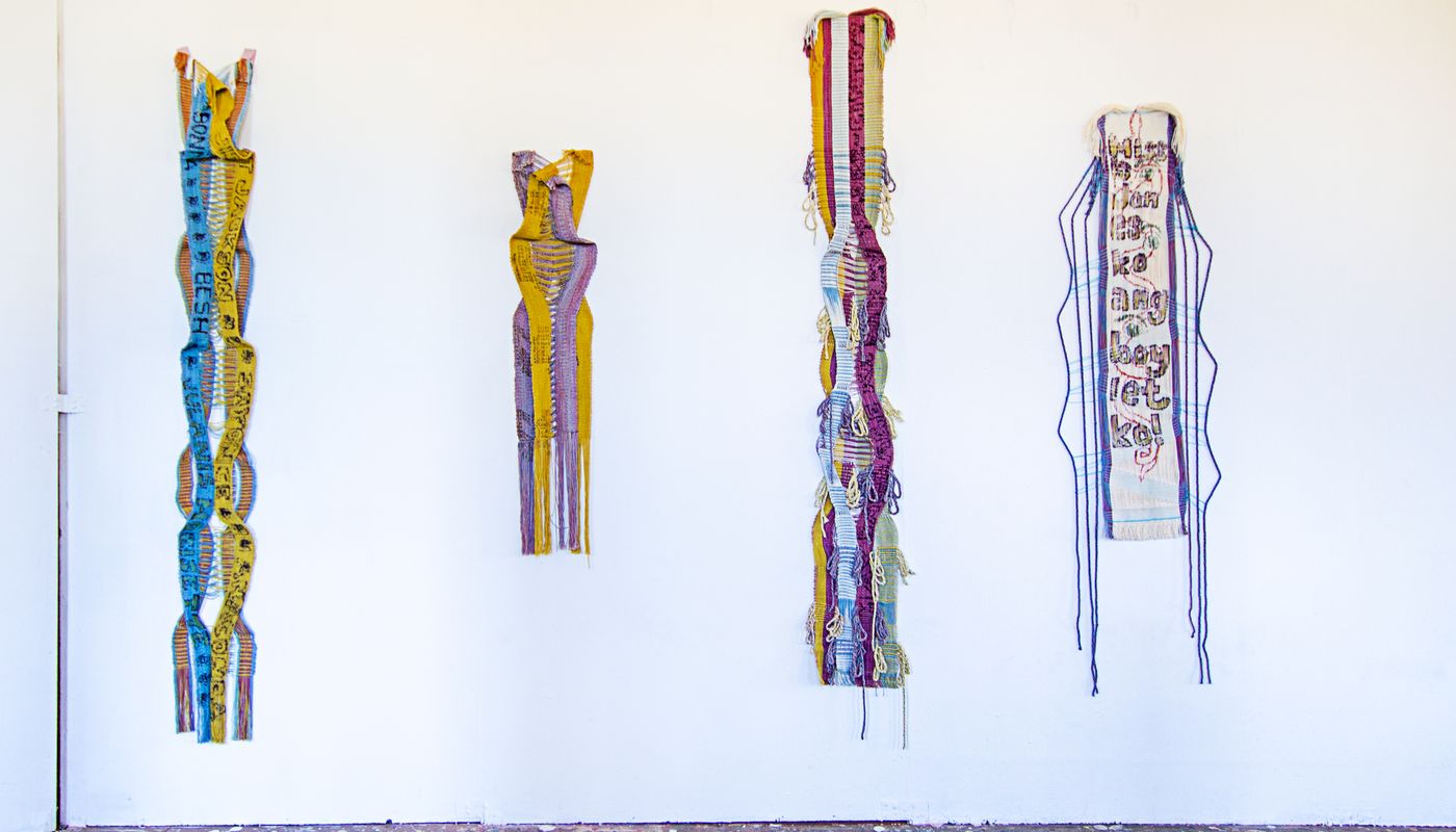 Colorful woven forms using backstrap weaving on fabric posts dyed with goldenrod, sappanwood, mulberry leaves, gardenia, annatto, logwood, and indigo.