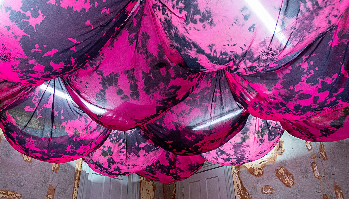 Bulbous voile fabric on the ceiling dyed in pink and black.