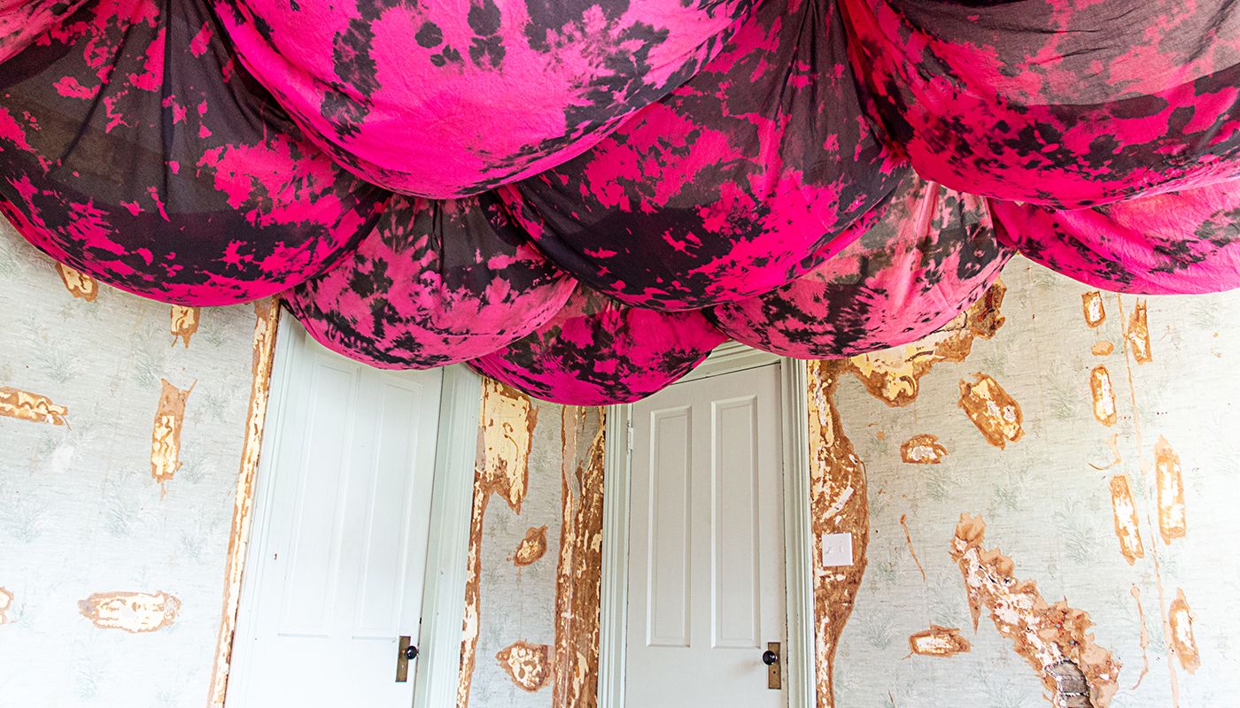 Bulbous voile fabric on the ceiling dyed in pink and black.