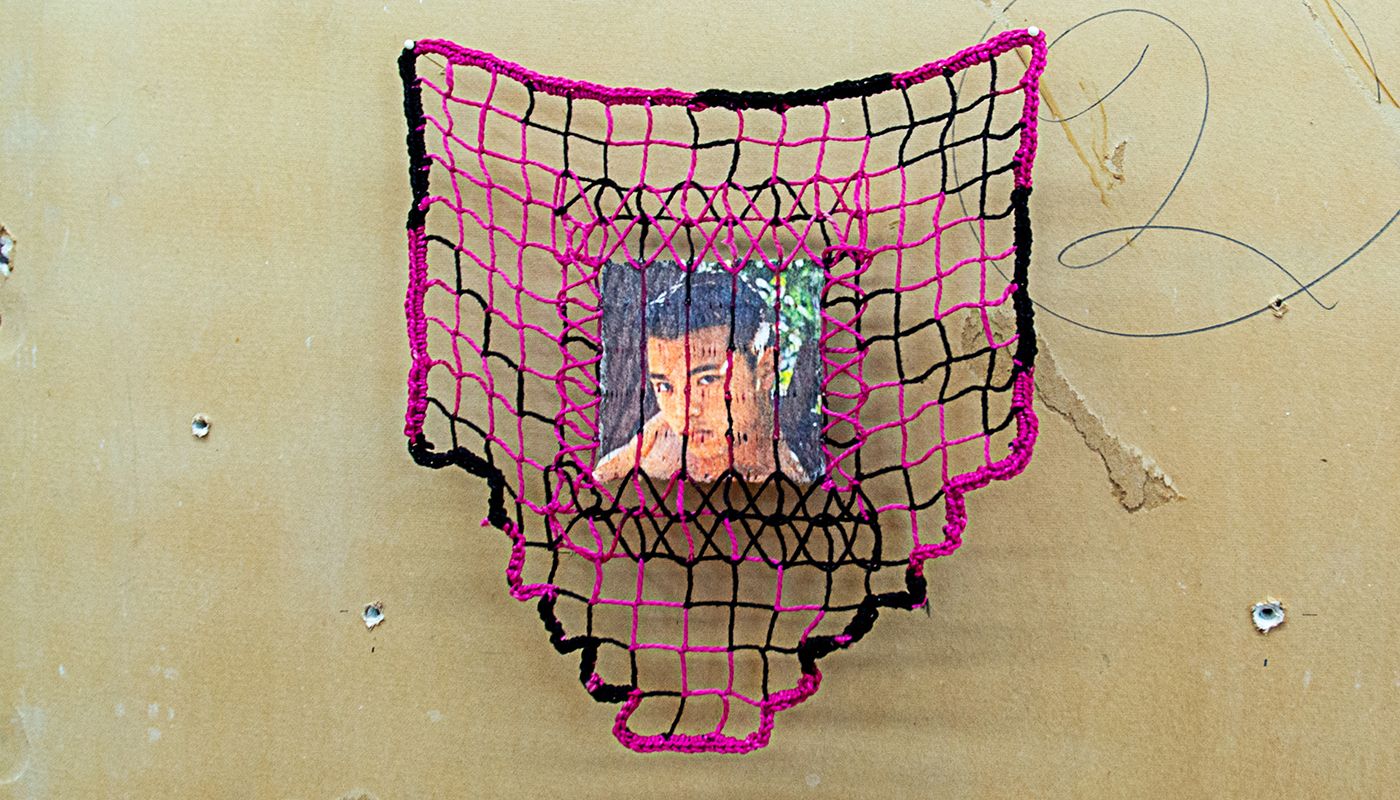 Pink and black filet lace embedded with gay pornographic image using a sublimation dye technique.